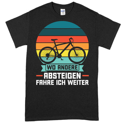 Design eines T-Shirts mit dem Slogan "wo andere absteigen fahre ich weiter" und einem stilisierten Fahrradmotiv, ideal als Geschenk für Fahrradliebhaber.